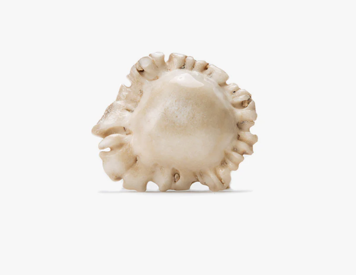 Decorative shell-like deer burr lapel pin on a white background