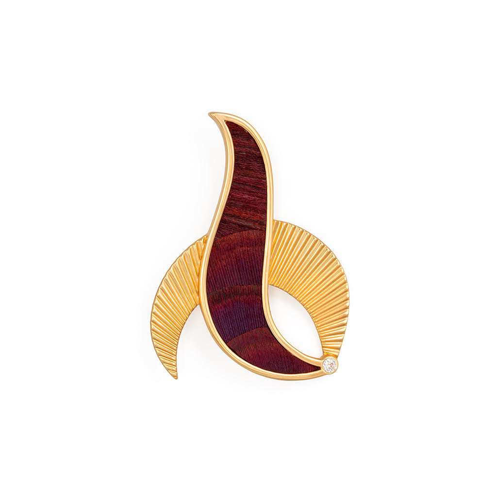 Gold and burgundy abstract brooch on a white background
