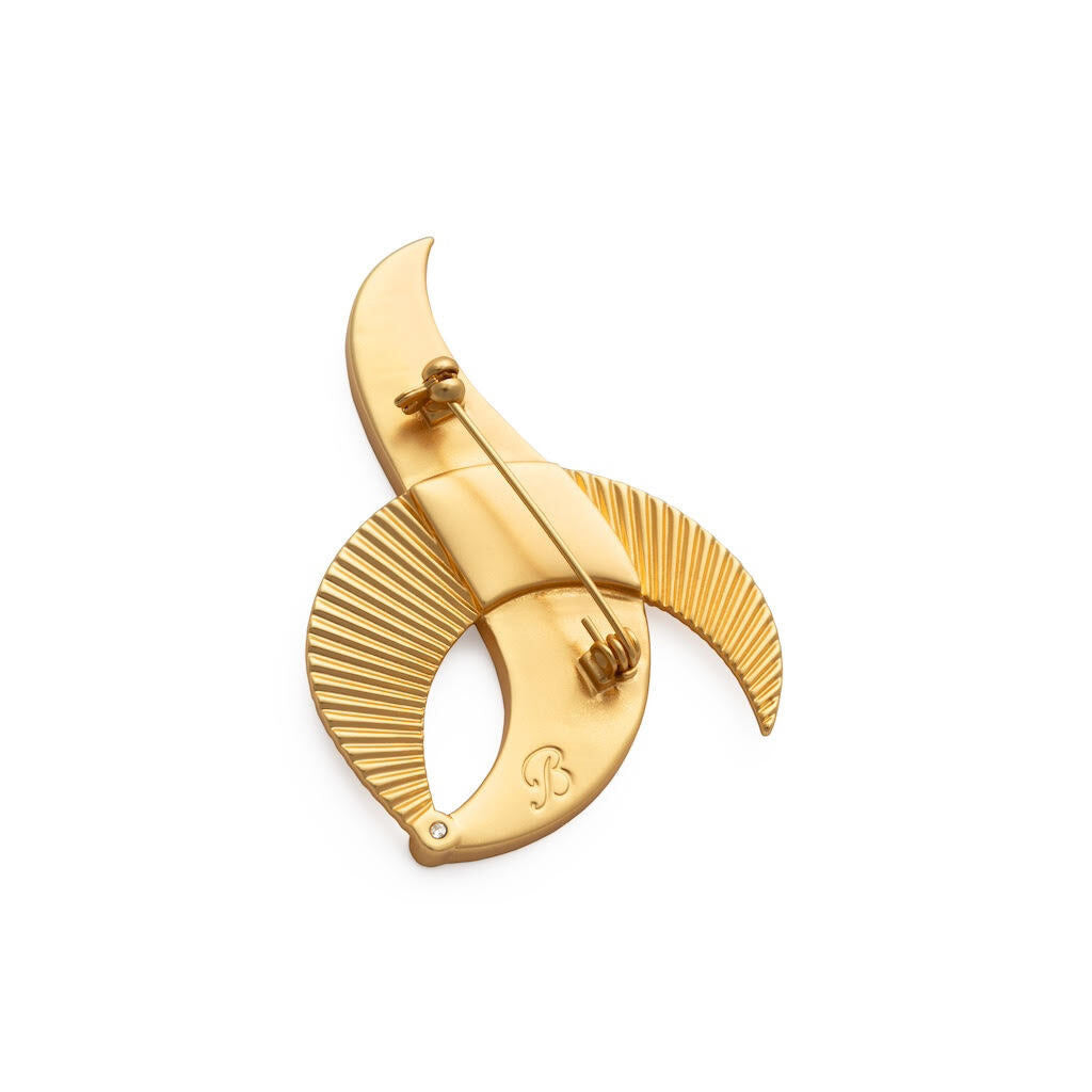 Gold brooch with Brackish logo on a white background