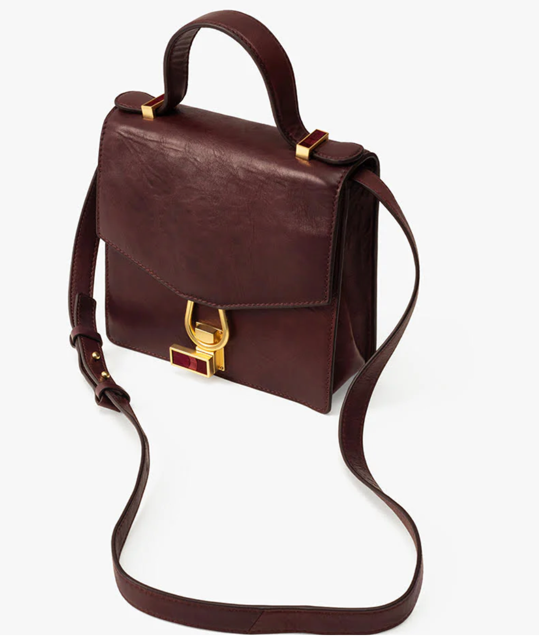 Alternate front view of brown leather handbag with a gold clasp featuring maroon feather inlay on a white background