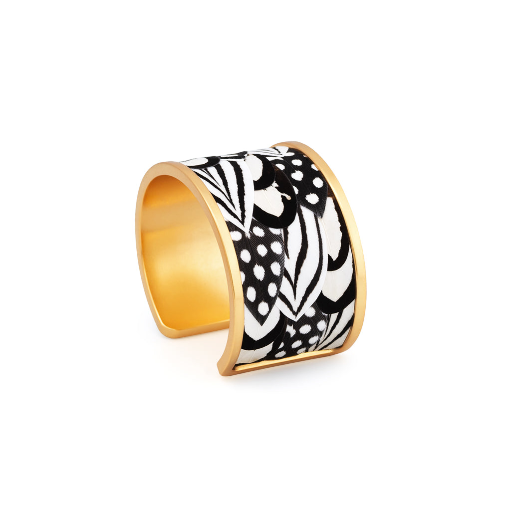 Alternate view of wide gold cuff with black and white feather inlay on a white background