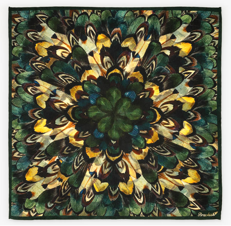Unfolded green, yellow, and brown pocket square with Brackish logo in lower right corner on a white background