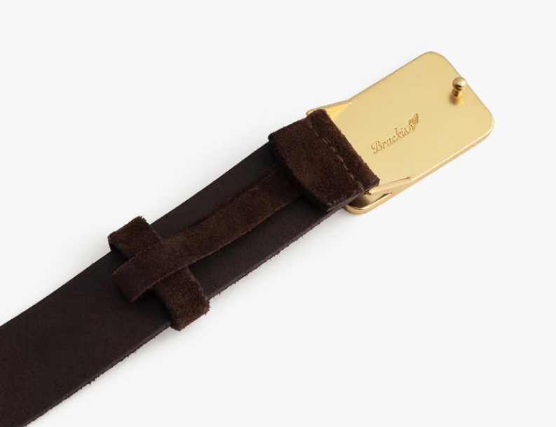 Back side of gold buckle featuring an engraved Brackish logo on a brown leather belt