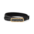 Black leather belt size large with a black and white patterned gold buckle on a white background