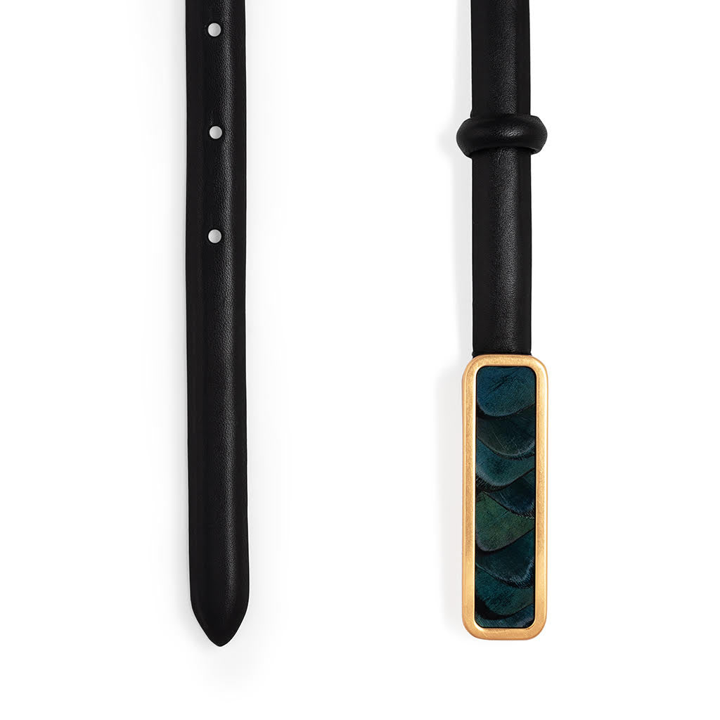 Ends of size XL black belt with a green and blue feather inlaid gold buckle on a white background