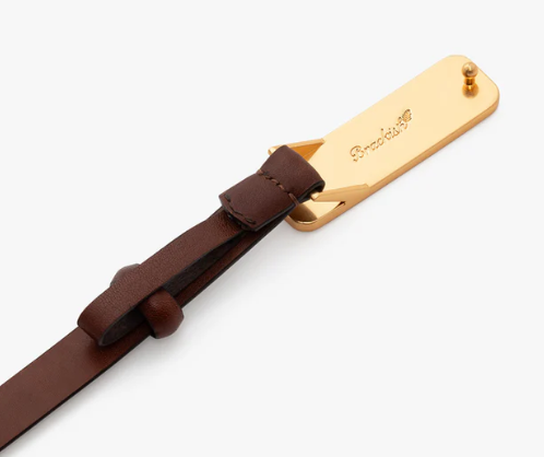 Back of gold buckle featuring Brackish logo on a size M brown leather belt on a  white background