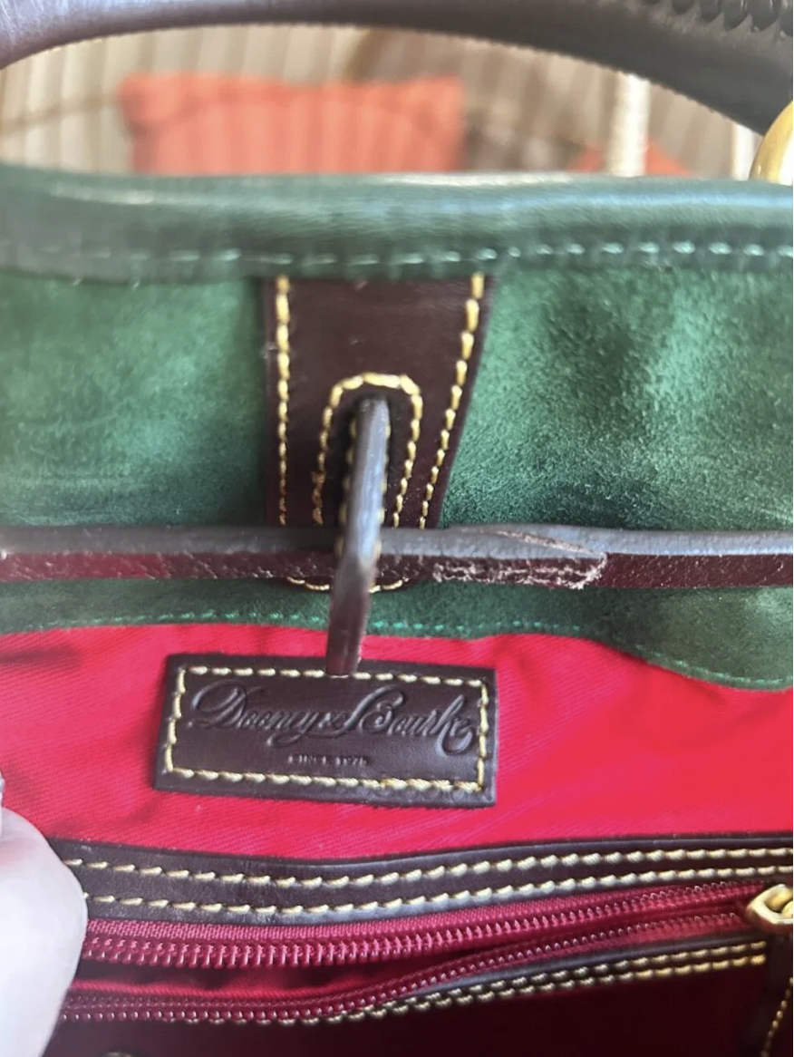 Close-up of leather Dooney & Bourke tag on red interior