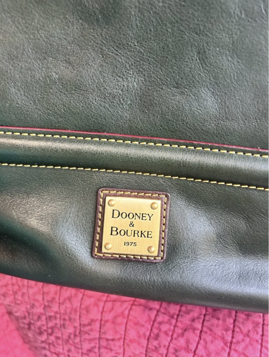 Dooney & Bourke logo on a green leather bag 