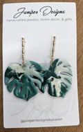 Tropical leaf earrings on a Juniper Designs card