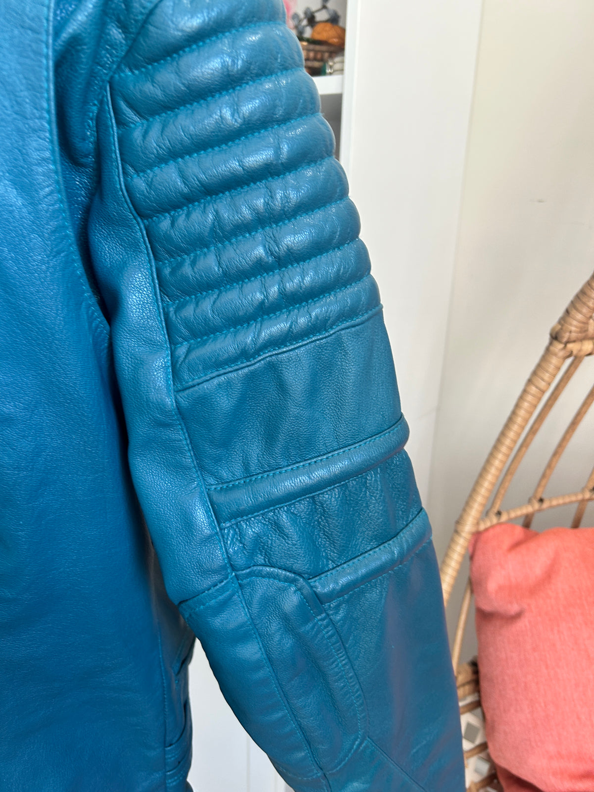 Close up view of the arm quilting of a teal leather motorcycle riding jacket