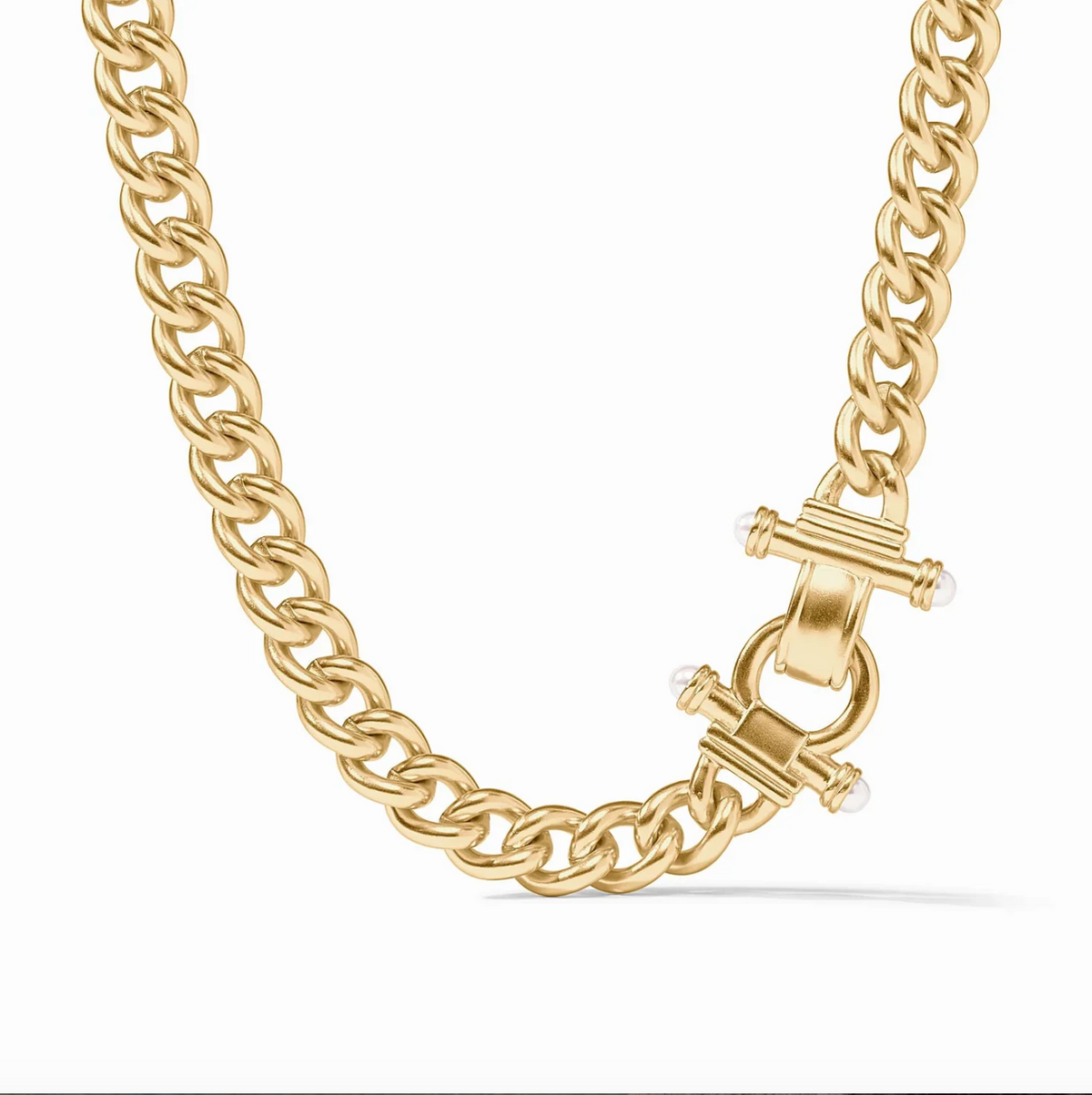 A gold chain necklace with an ornate clasp with pearls on a white background