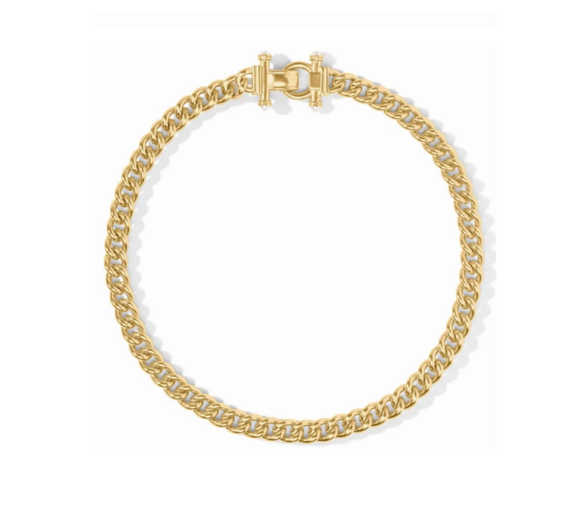 A gold chain link necklace on a white background