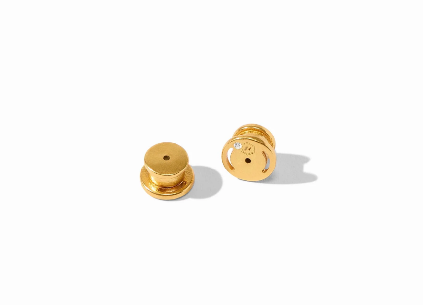 Gold earring backs on white background
