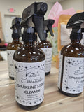 Two bottles of Katie's Essentials Sparkling Stone Cleaner on a wooden surface.