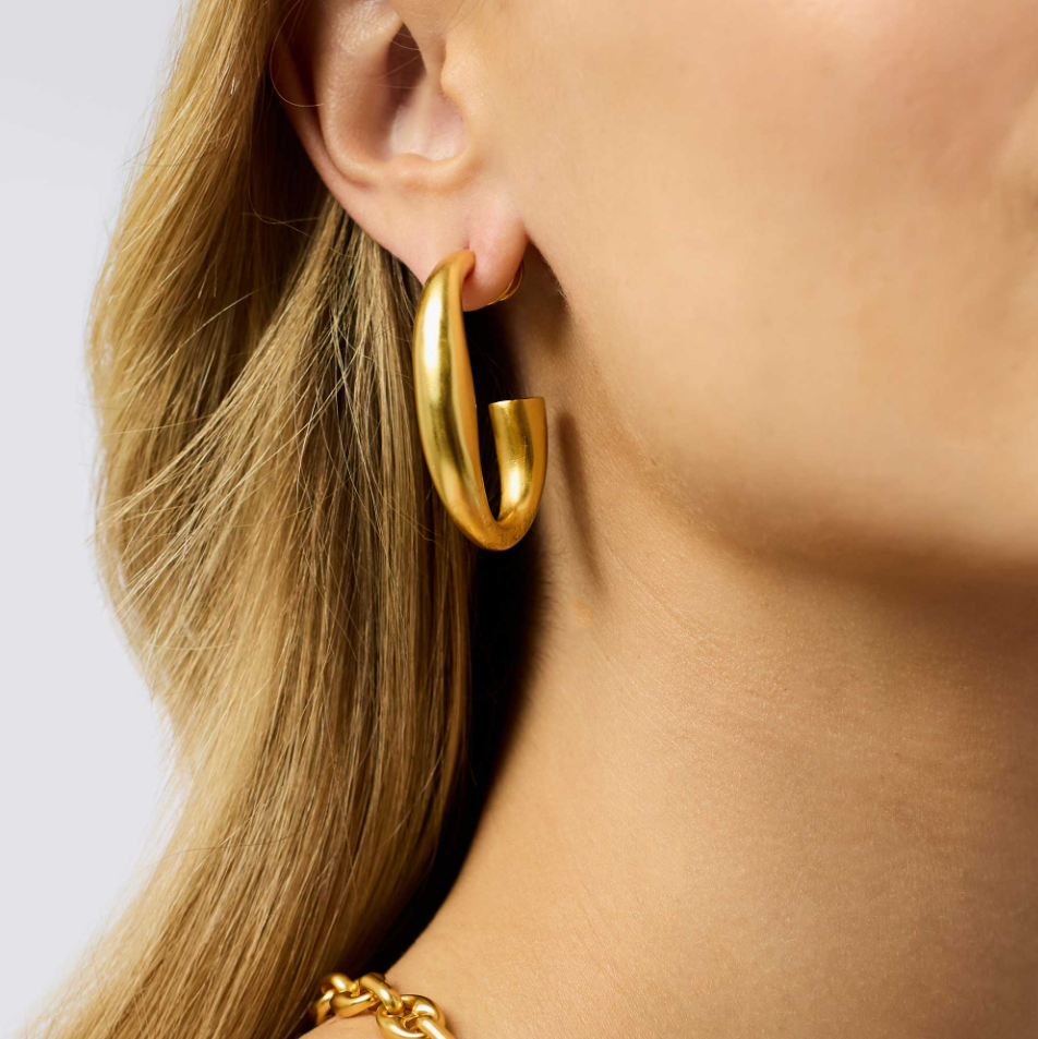 Model wearing a smooth gold hoop earring in size large.