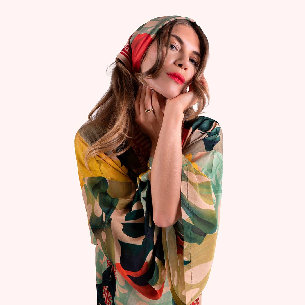 Woman wearing a colorful scarf with a white background