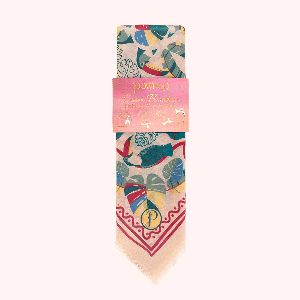Folded colorful patterned bandana with a pink packaging label on a white background
