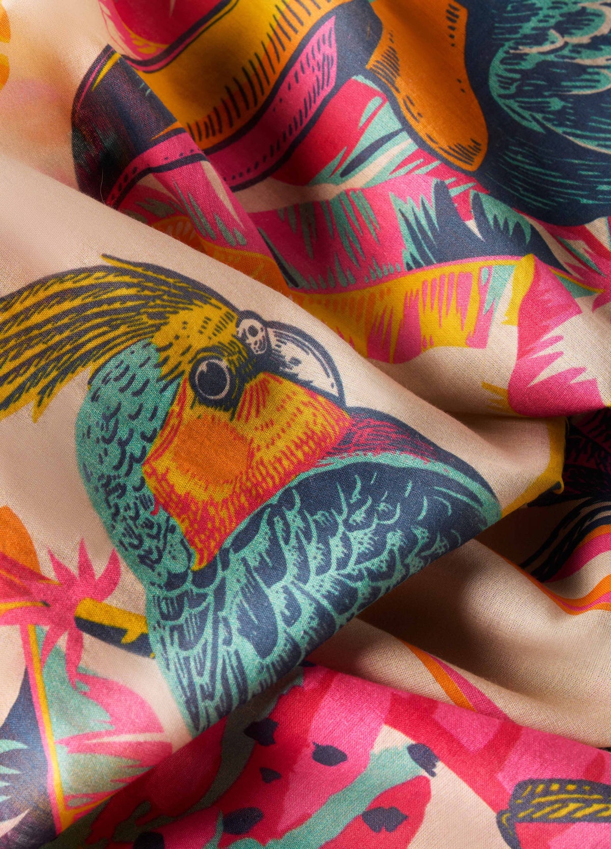 Close up of colorful fabric with tropical bird illustrations