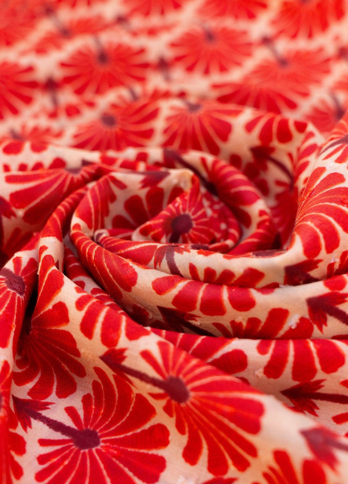 Close-up of red floral patterned fabric of scarf