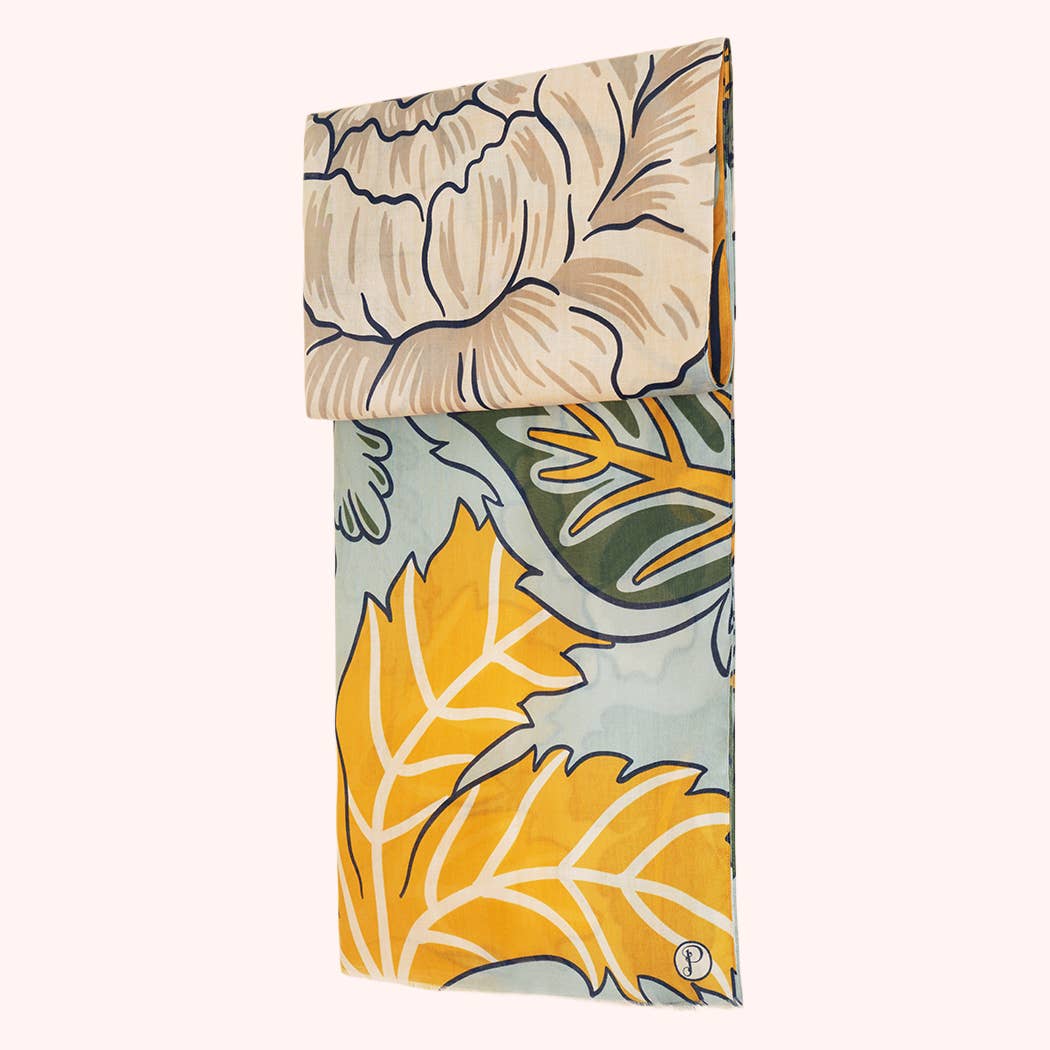 Full view of a folded green, yellow and beige floral print scarf on a white background