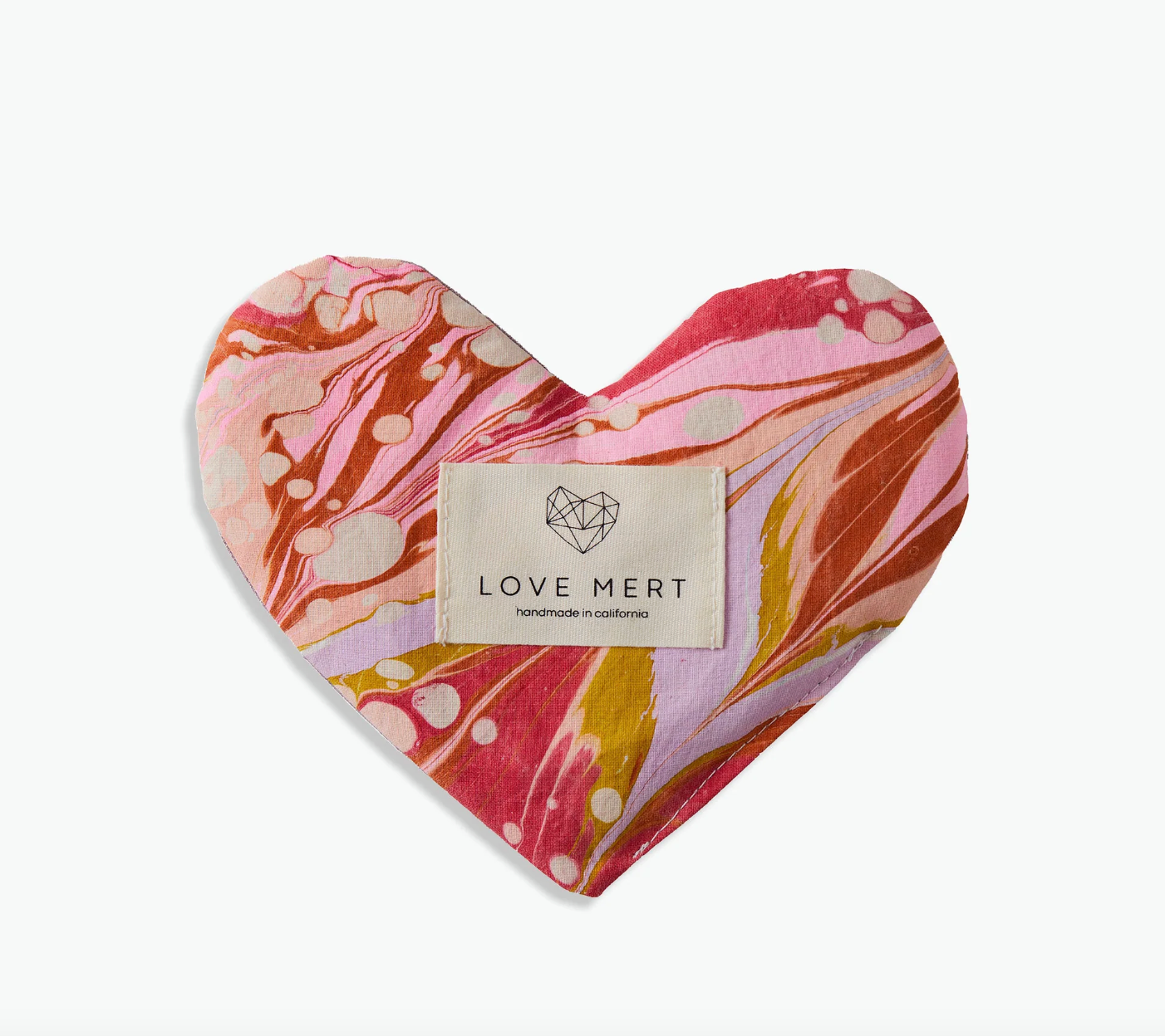 Heart-shaped product with marbled pattern and 'LOVE MERT' label on a white background