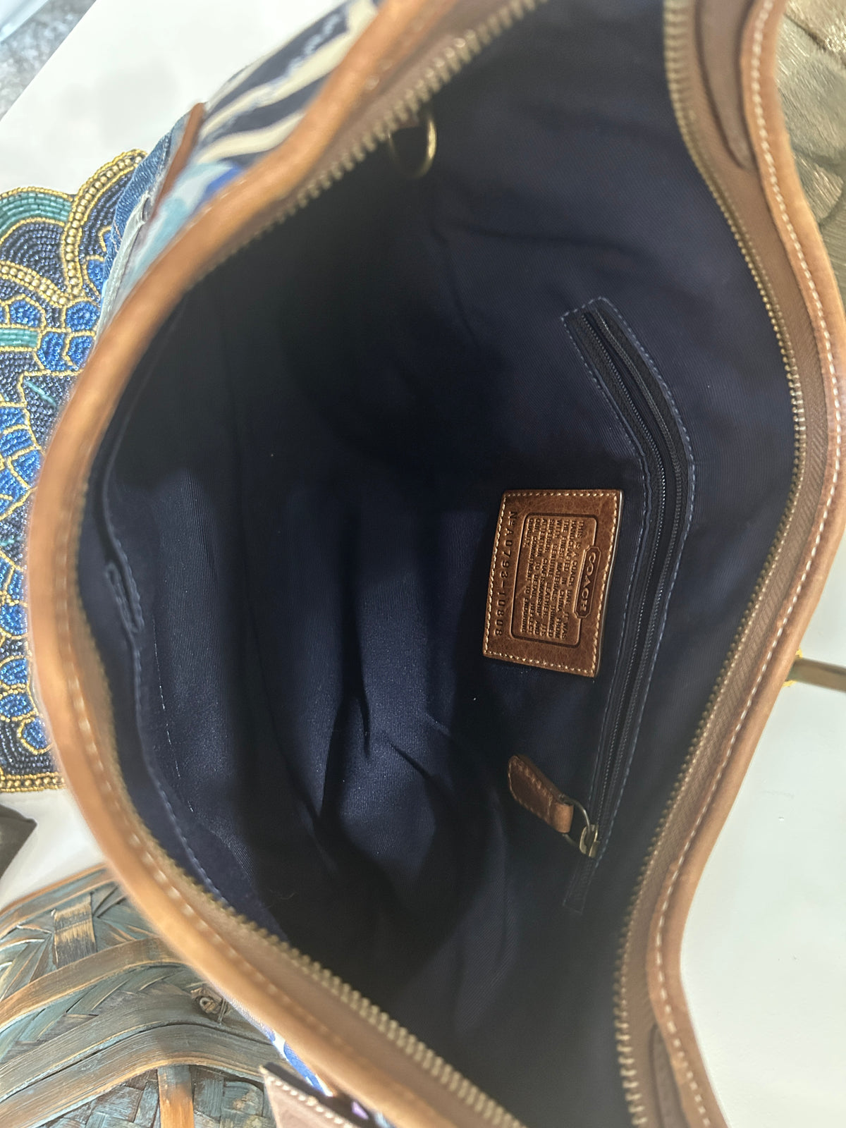Interior shot of a brown leather lined bag with blue interior