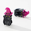 Black cat-shaped hairclips with purple witch hat on a white background