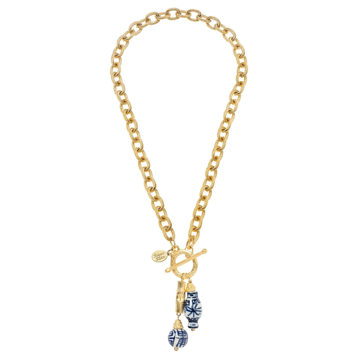 Gold chain necklace with blue and white ceramic pendant on a white background