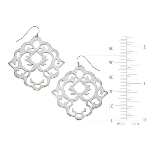 Silver filigree earrings with a measurement scale on a white background