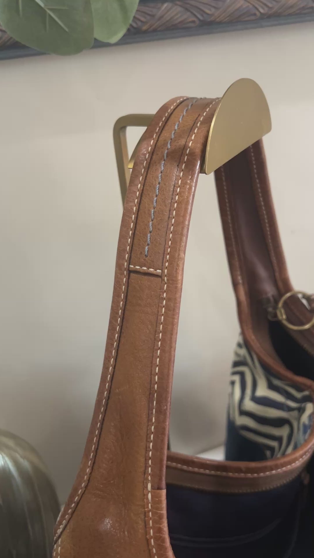 video scrolling over a blue, brown, and purple patchwork bag