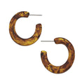 Pair of tortoiseshell hoop earrings on a white background
